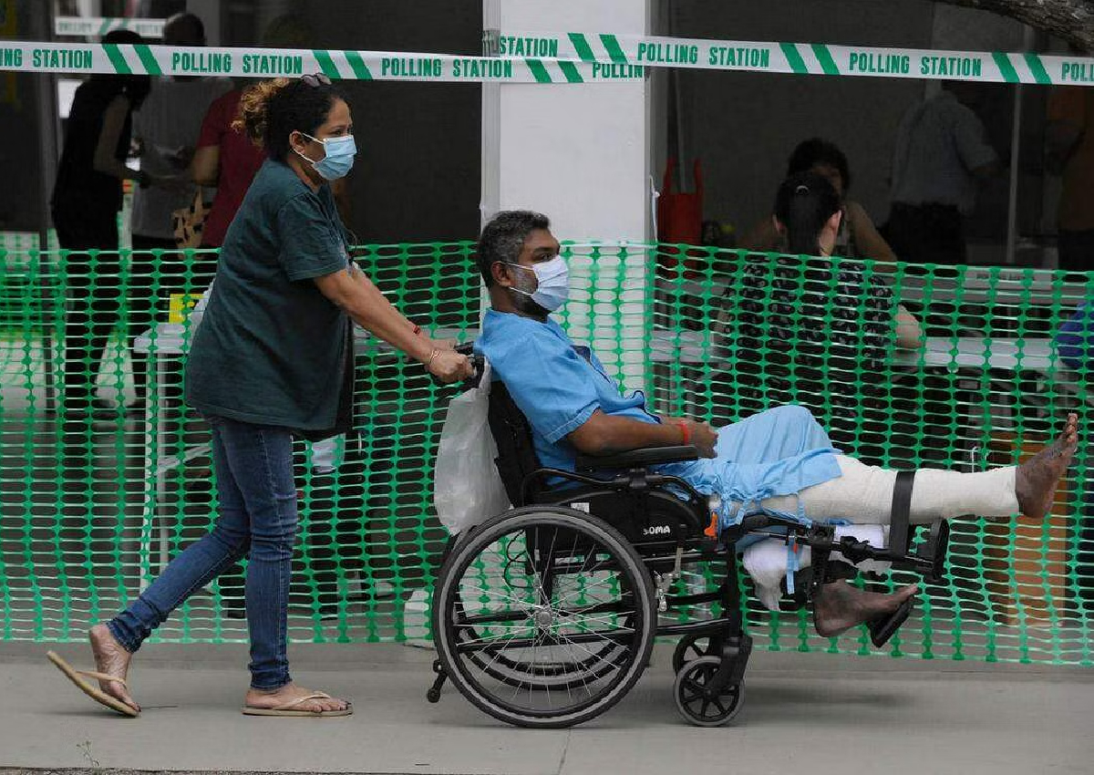 Hospital patient in leg cast, woman with hair curler Singaporeans vote